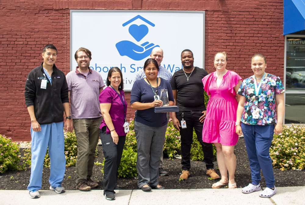 Gargi Cooper Honored with Beacon of Hope Award 1 RCC Team outside Building, Gargi holding Beacon of Hope Award