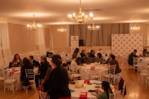 People sitting at tables for LCHC event