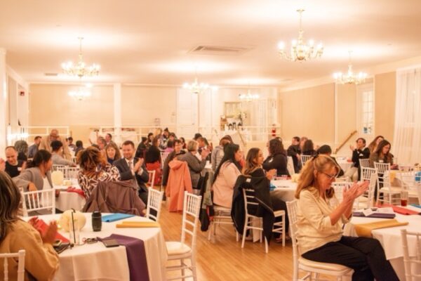 People sitting at tables for LCHC event