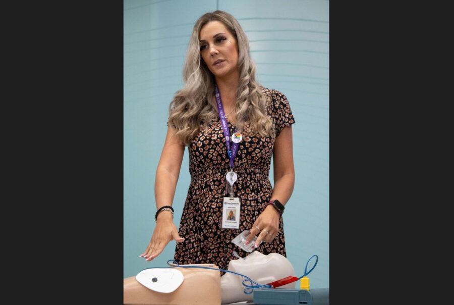 Staff doing a demonstration on a medical doll