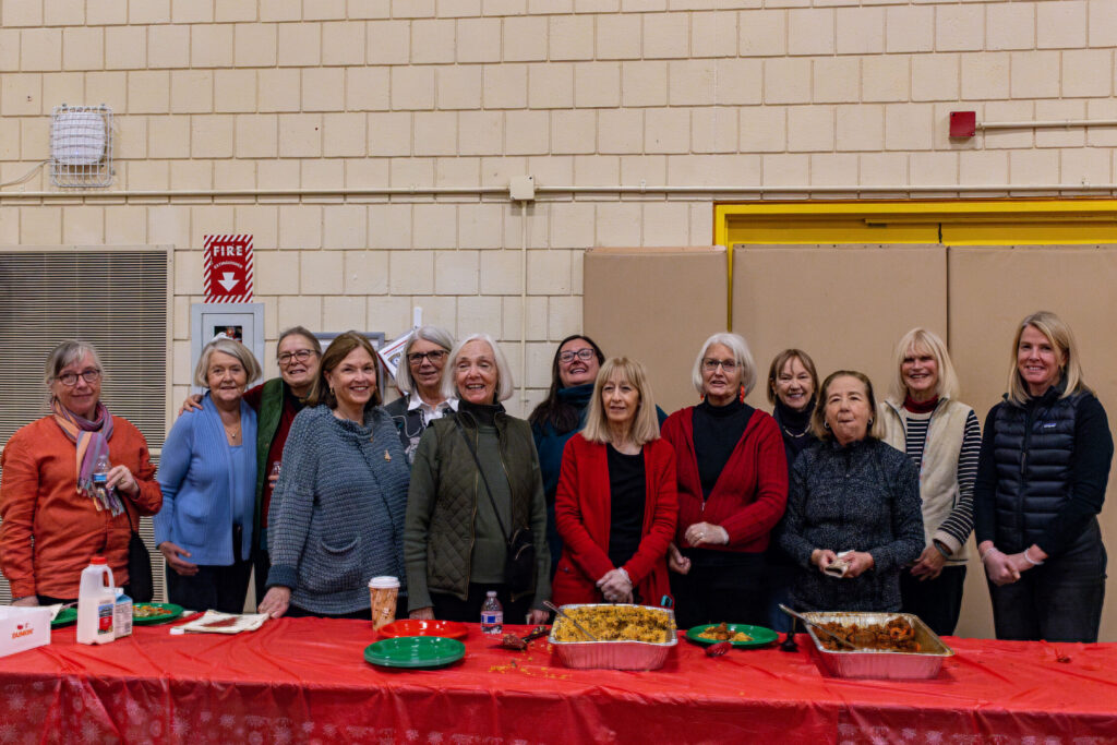 BFX_Baby_optimized_1000 Group of people in front of table of food posing for picture