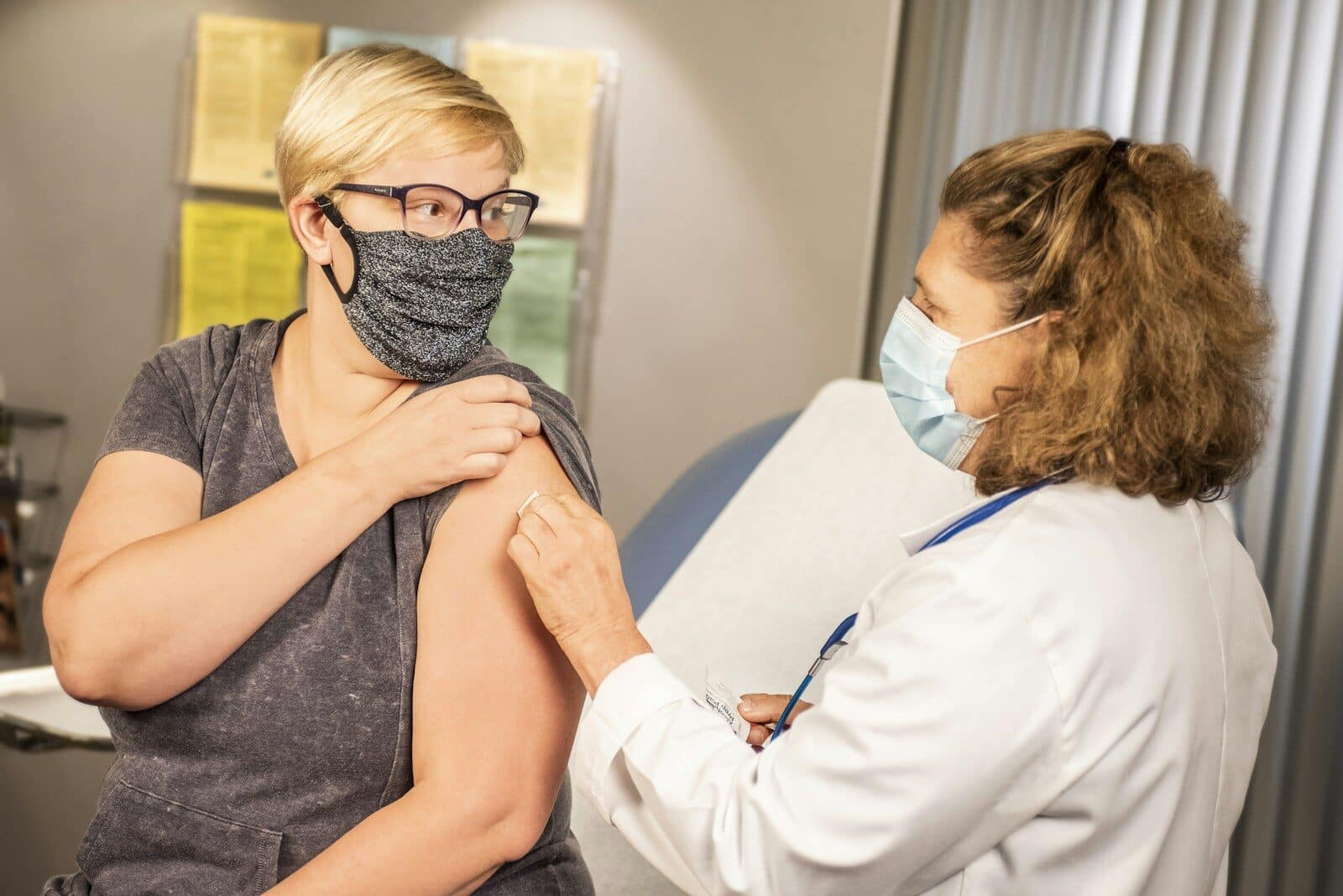 woman getting flu shot from a doctor.