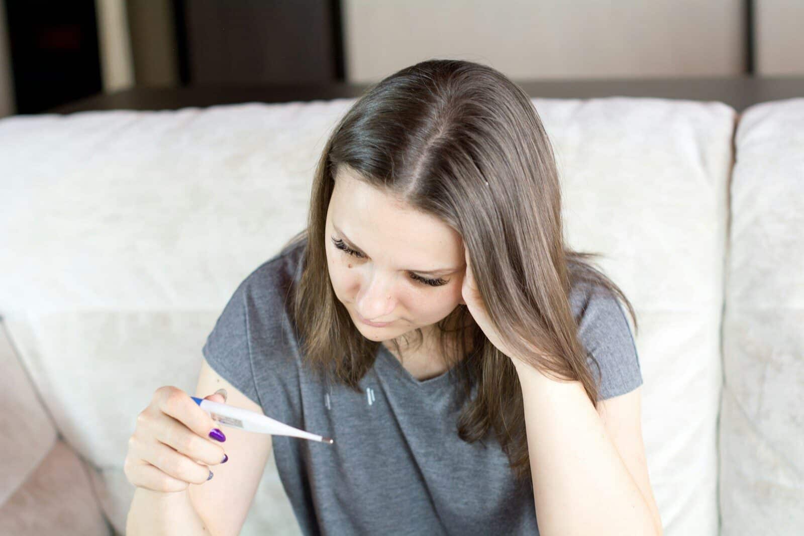 Is It a Cold or the Flu? How to Tell the Difference and When to Visit Urgent Care 1 Thermometer showing fever as a sign of flu versus common cold